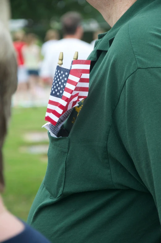 a man with two wooden sticks holding american flags