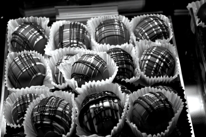 a box filled with dark chocolate truffles sitting on top of a counter