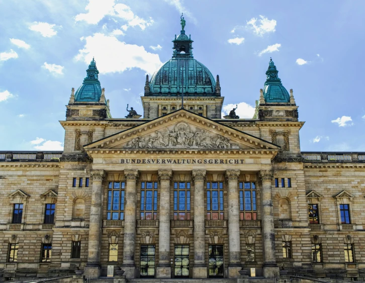 a large stone building with windows and two spires