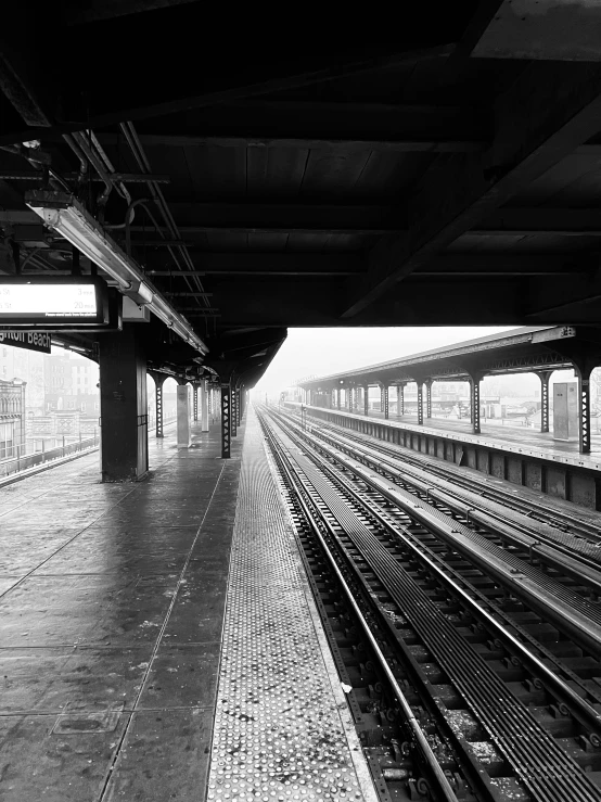 train tracks line up in an empty train station