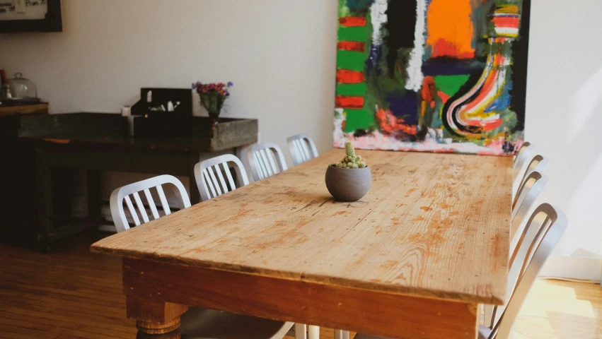 the dining table has a wooden table with white chairs