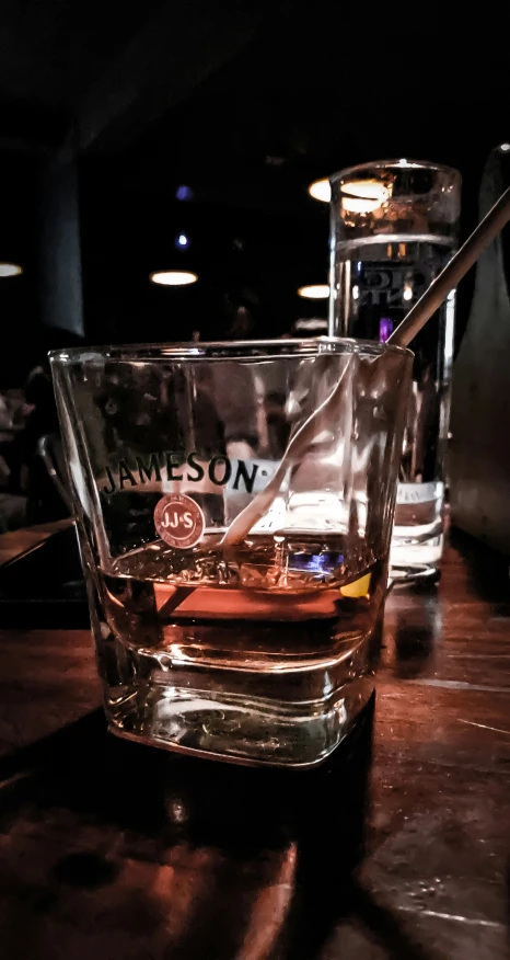 a glass sitting on top of a wooden table