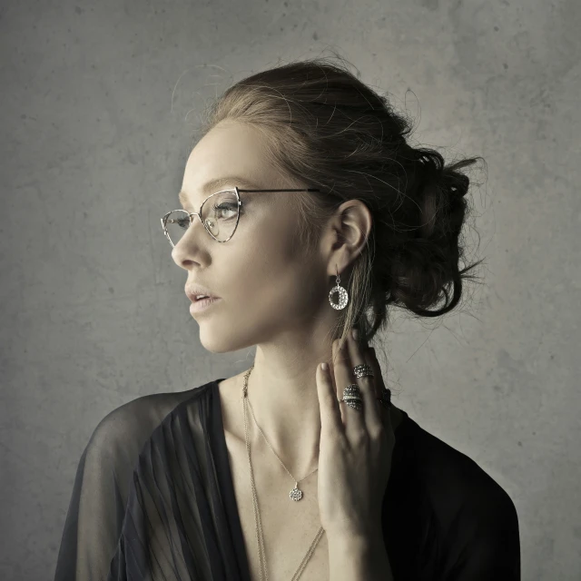 a woman wearing glasses is wearing jewelry