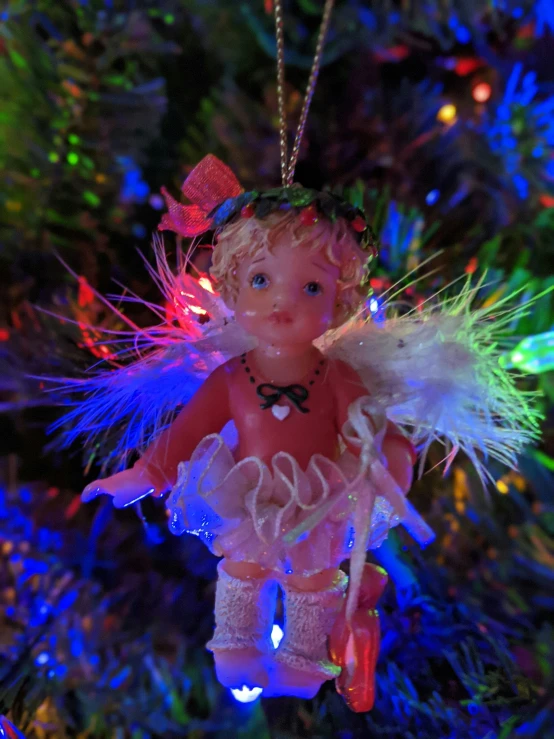 a christmas tree is decorated with an angel ornament