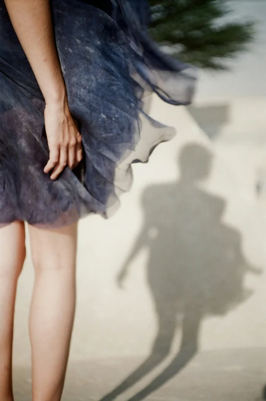 a person casts their shadow on a sand dune