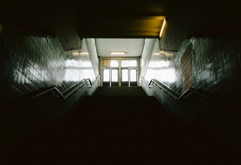 stairs leading up to a window with a wooden railing