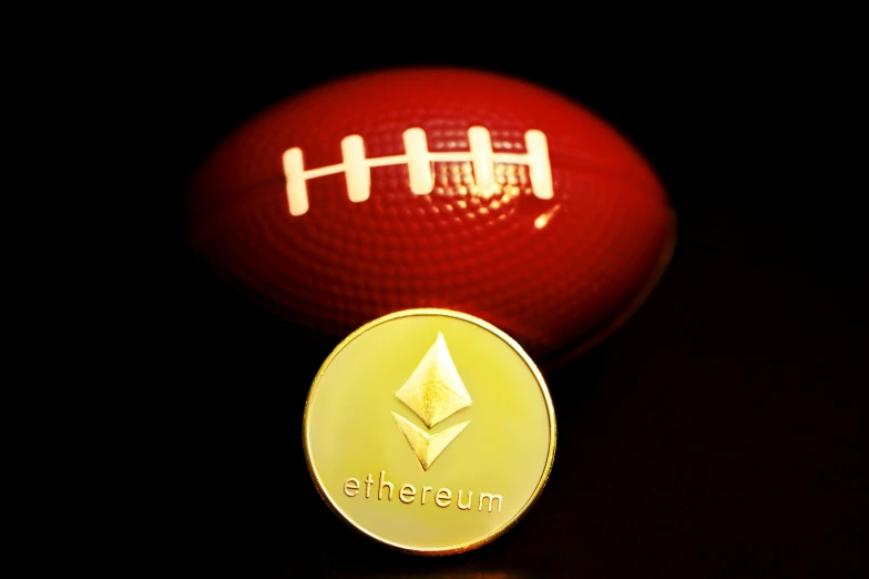 a red and yellow football with the words ether on it