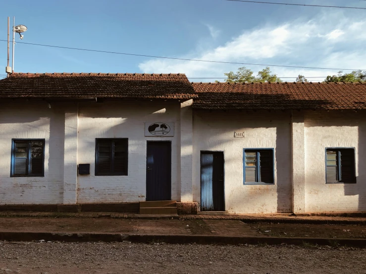 a row of three windows next to a white building