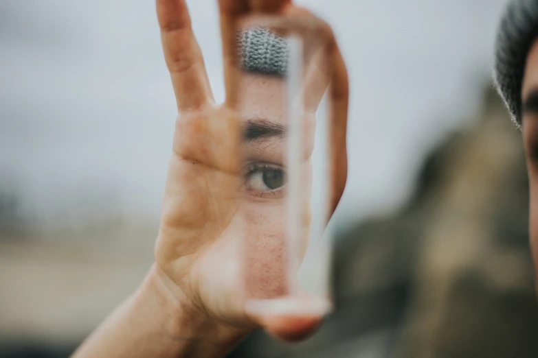 a person with their hands extended in the air, holding up an object