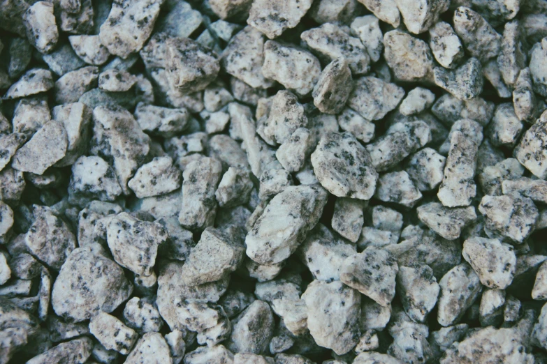a bunch of small grey rocks together
