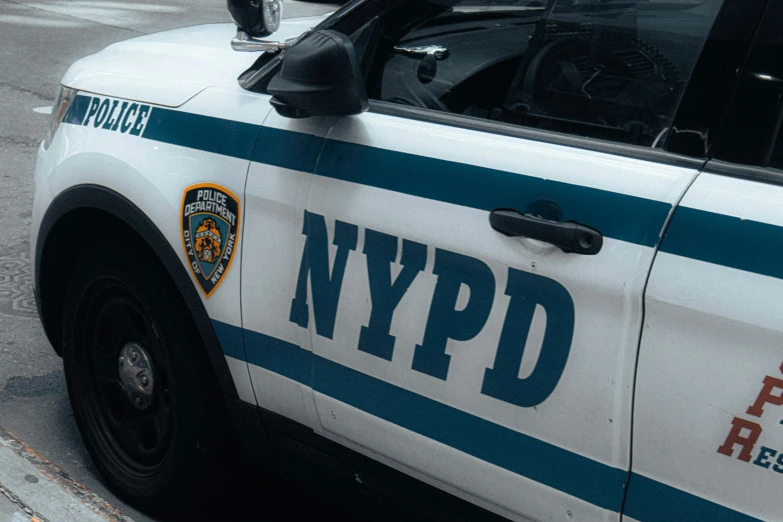 a nypd police car parked at a red light