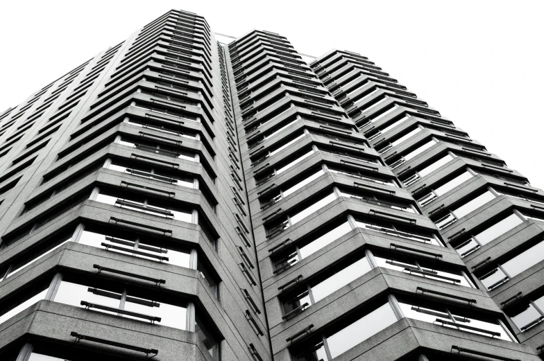 black and white po of tall building, with balconies