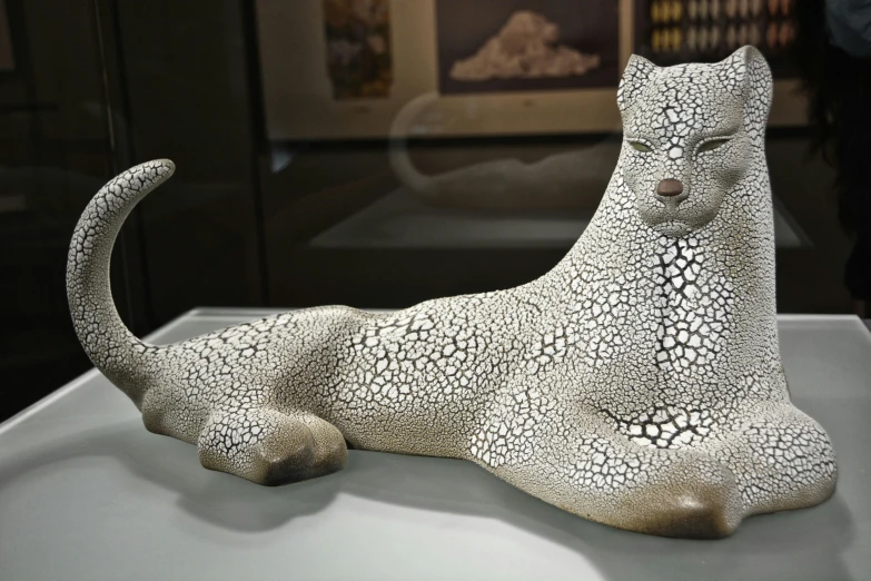 a small sculpture of a cat that is on display