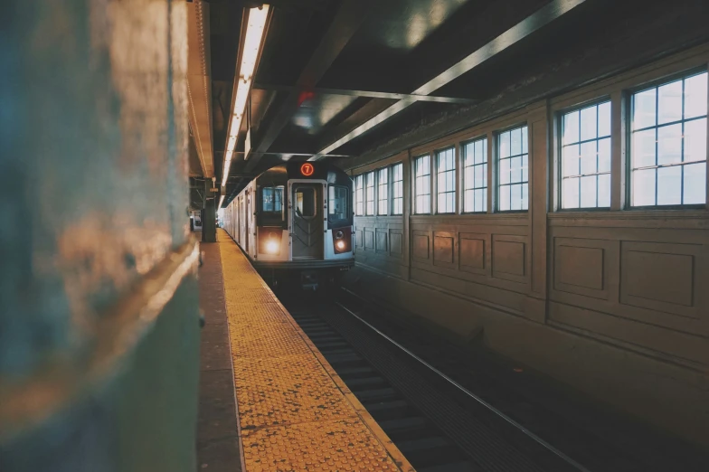 a train is moving down some tracks near windows