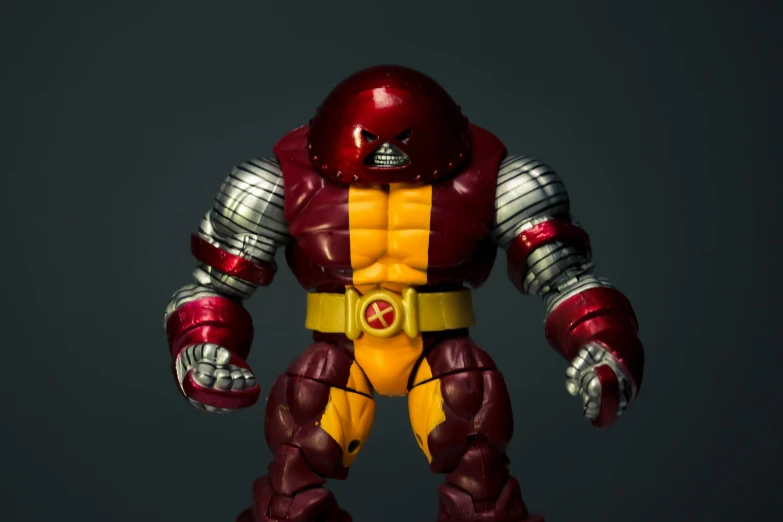 a close up of a toy figure in red and yellow