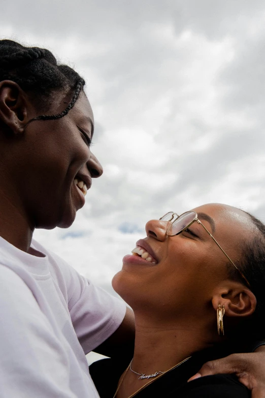 a man and a woman laughing together outside