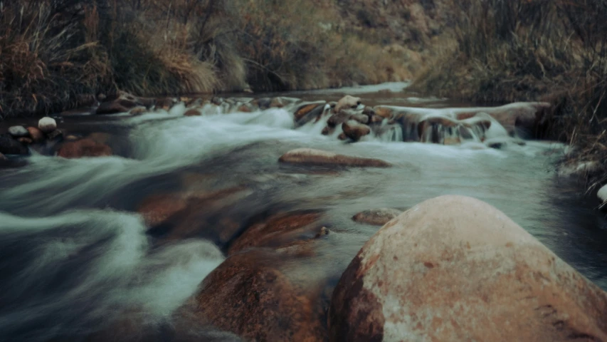 some large rocks in a body of water