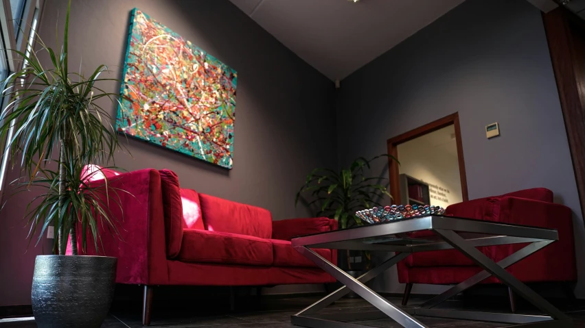 a living room with red couches and a coffee table