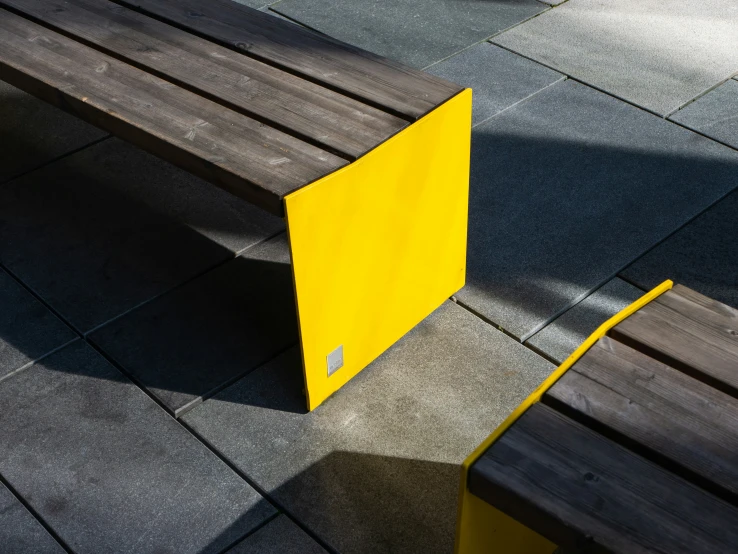 a yellow and black door is shown on a sidewalk