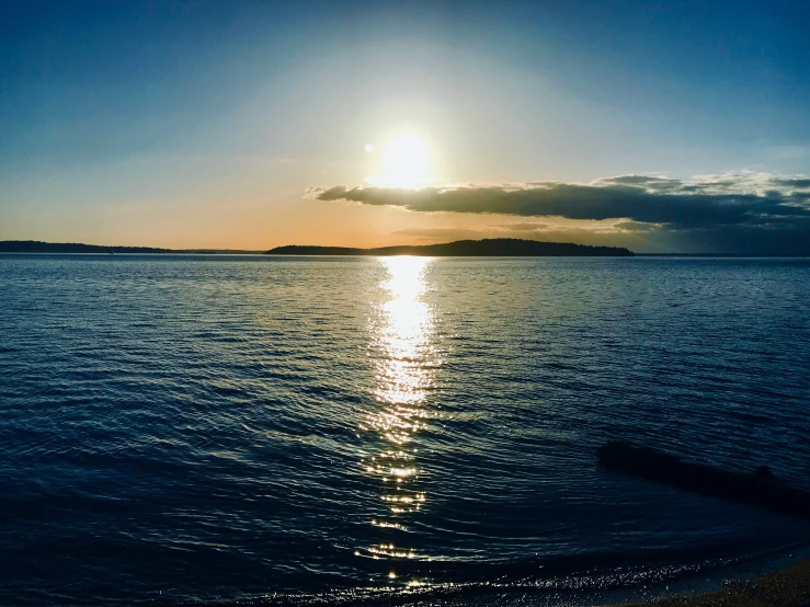 an evening on a lake with sun reflecting off the water