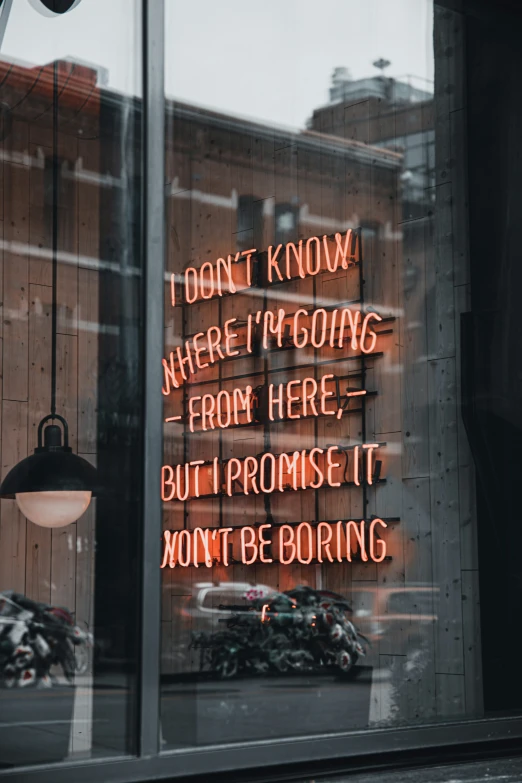 a storefront with neon sign in the window