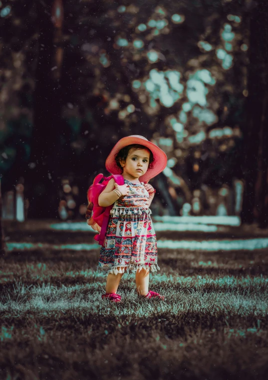 a  is in a field with a pink hat