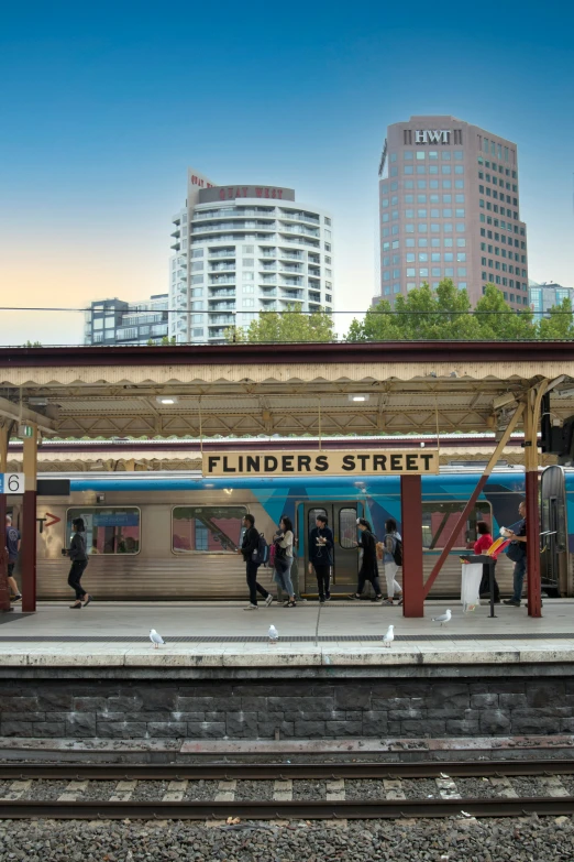 a bunch of people standing outside of a train station