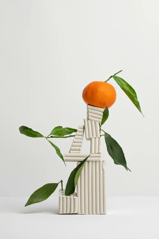 an orange sitting on top of an old chair