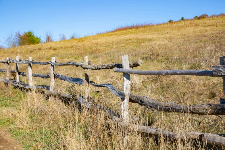 the view of a fence that is in front of a hill