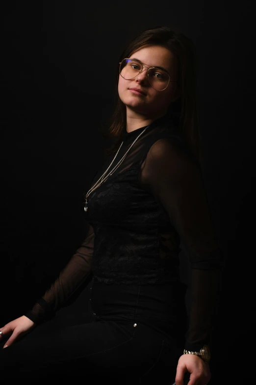 a woman in black dress posing for a picture