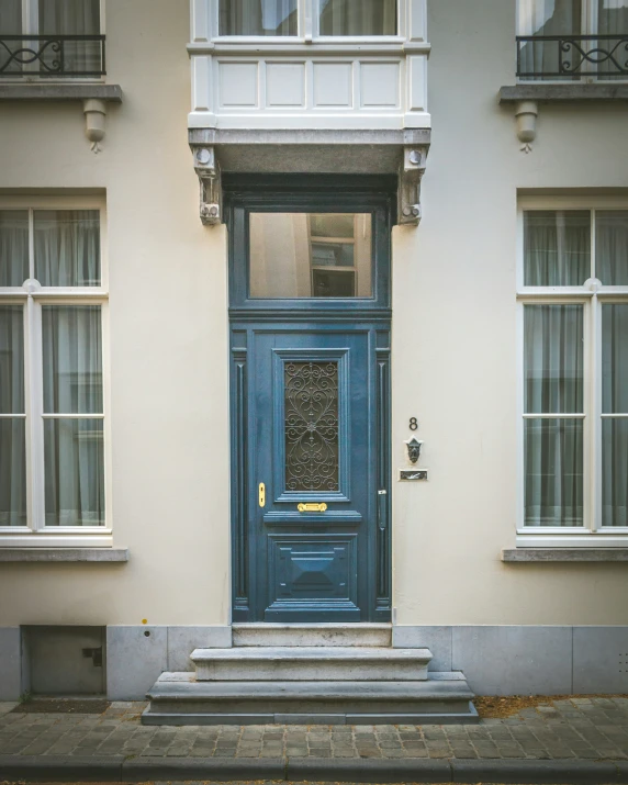 a large blue door is in front of a building