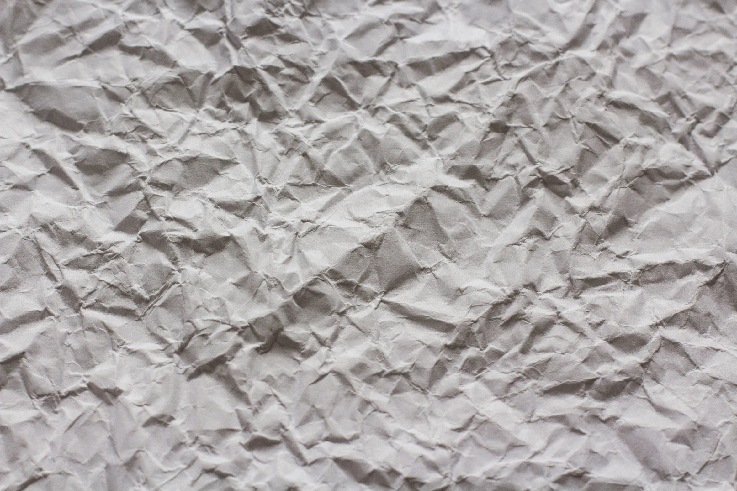 wrinkled paper with white edges, showing some gray paint
