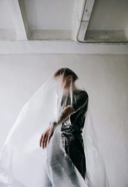 a woman wearing a veil while standing on a ledge