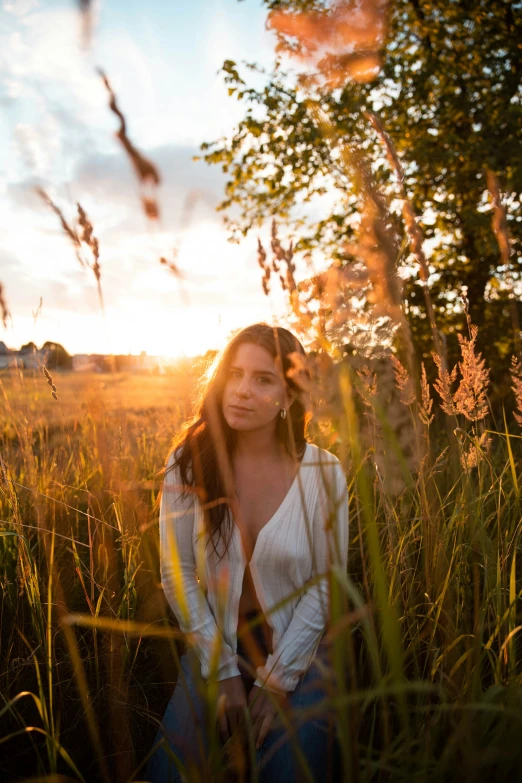 a woman that is standing in the grass