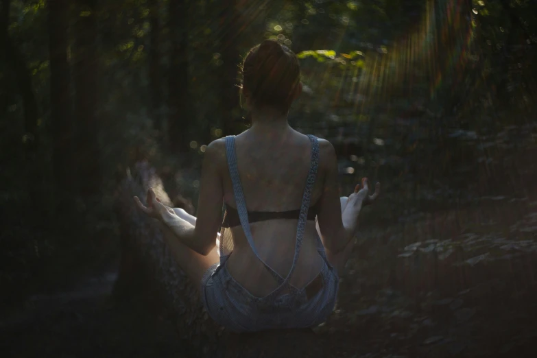 a woman in the woods with her back turned