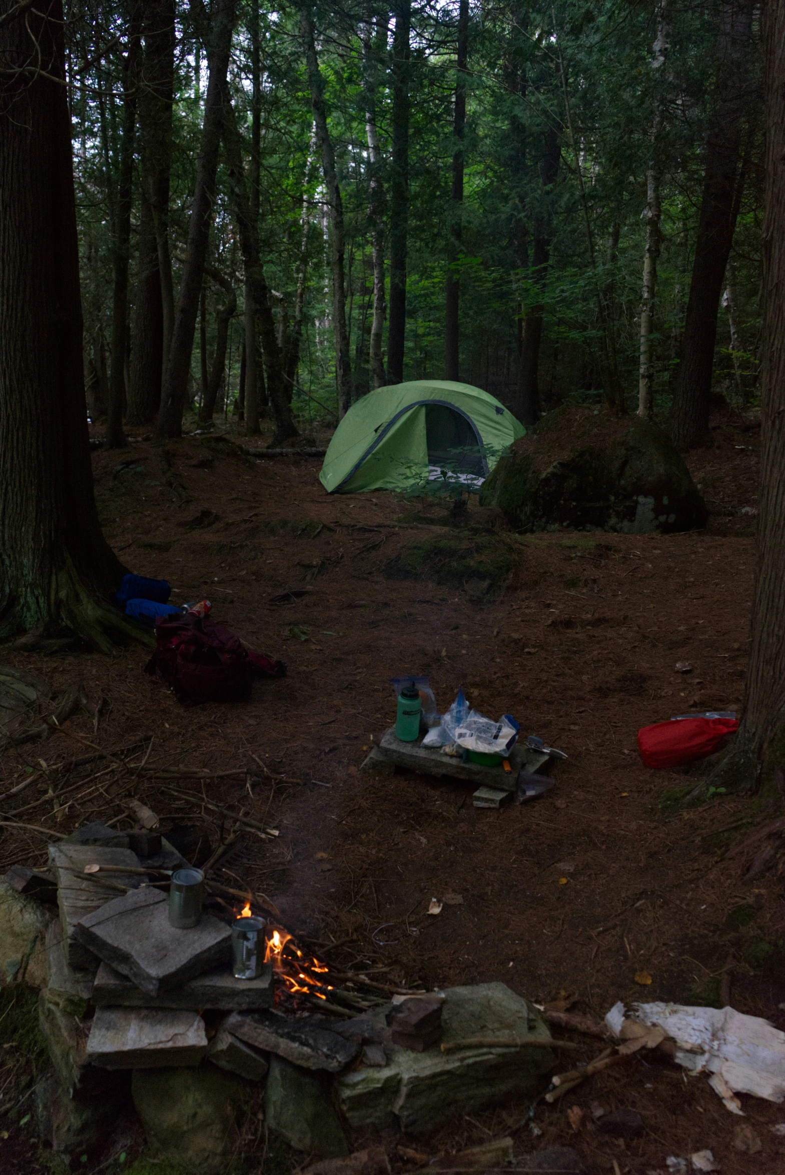 a camp site with tent and cooking stove