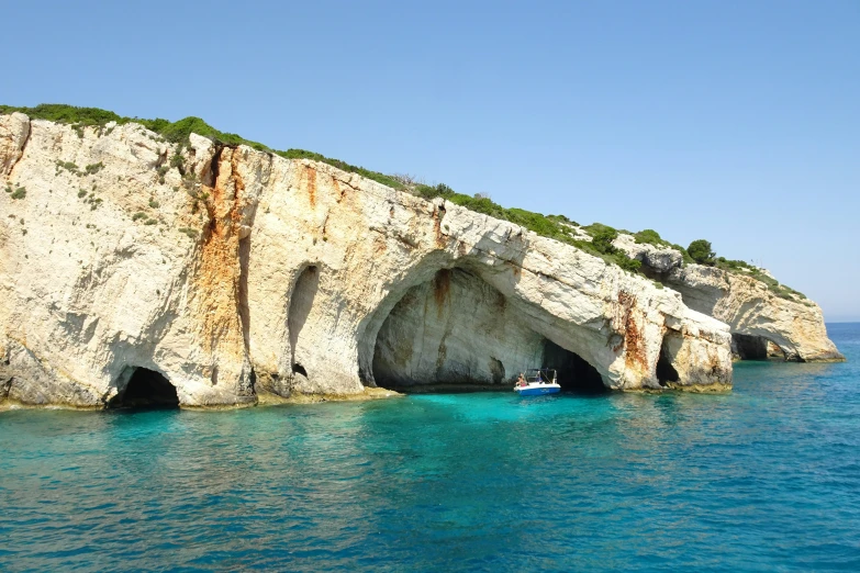 the ocean has blue waters and a very large rock formation