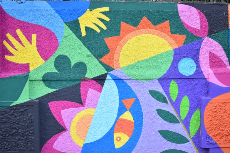 a brightly painted, colorful flowered background on the side of a wall