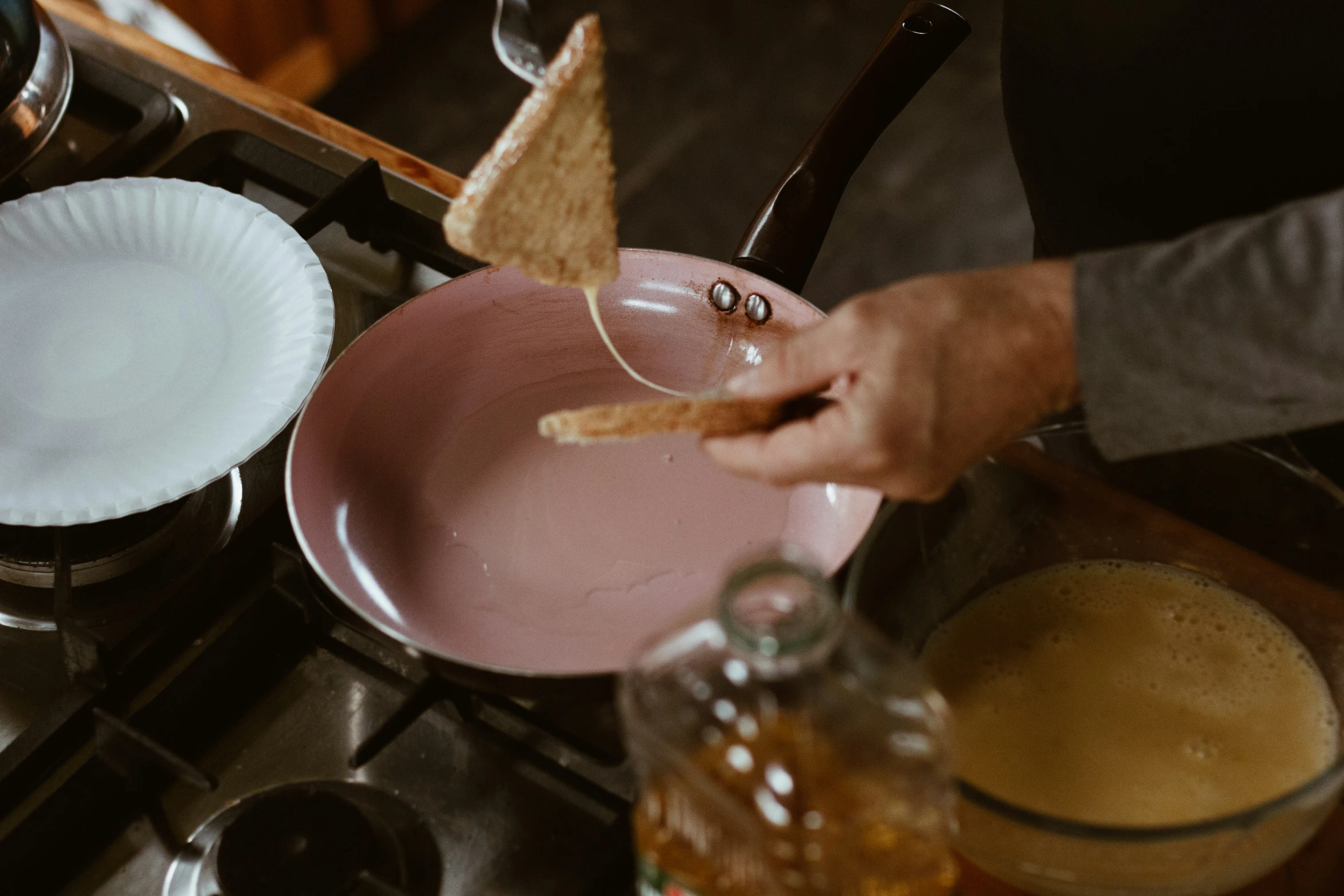 someone holding onto an empty plate in a kitchen