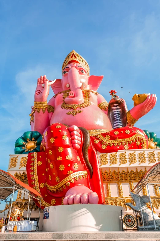 a statue of a giant buddha with his hands in his mouth