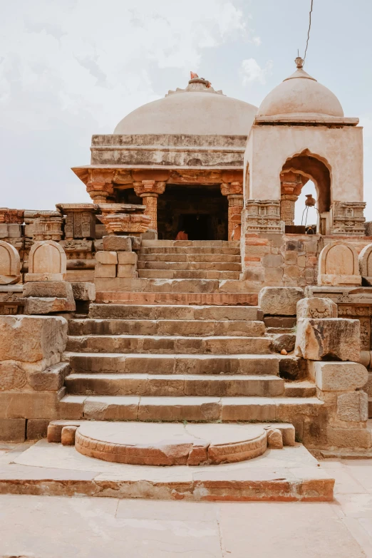 stone steps leading to an entrance into a palace