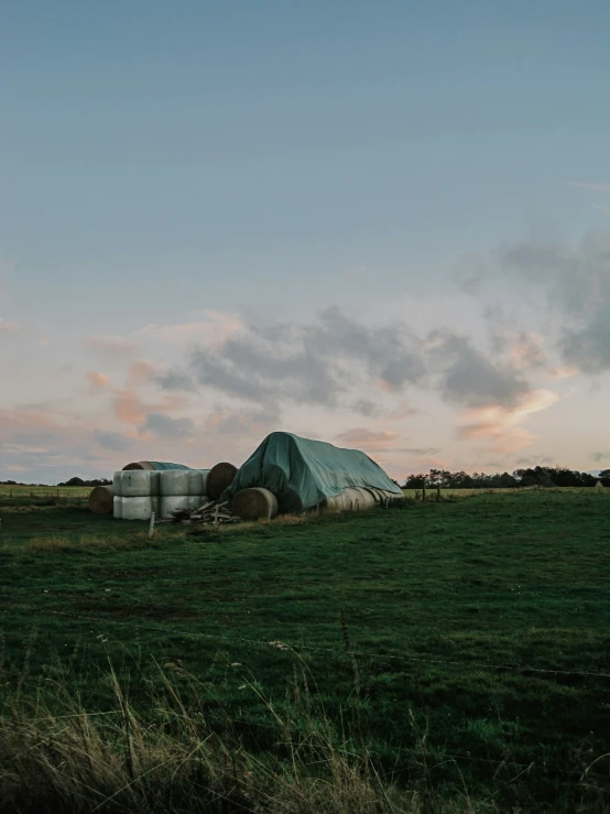 an old barn in a field on a farm