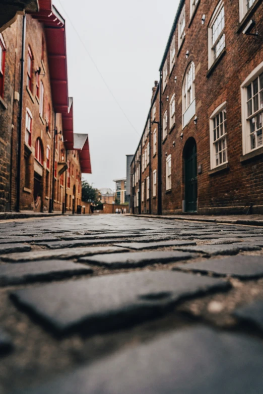 the empty road has stones and cobblestones on it