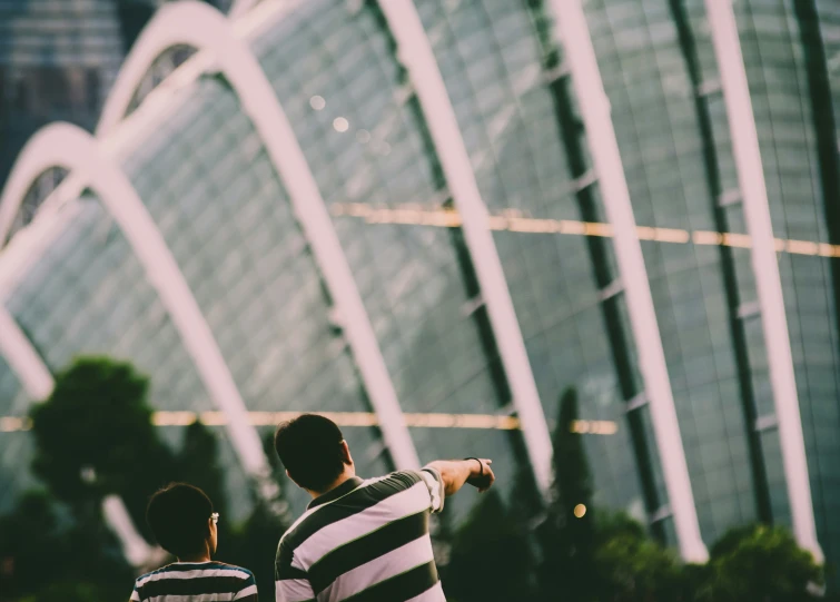 two people with their arms around each other watching soing in the distance