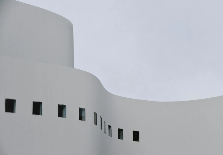 a clock tower against the white architecture of an airport