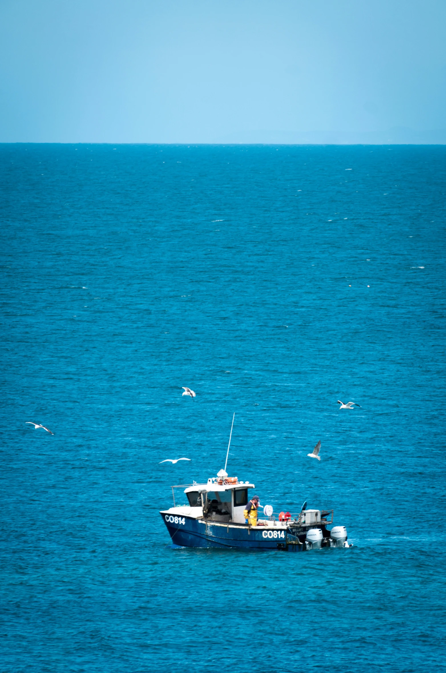 a small boat sailing in an empty ocean