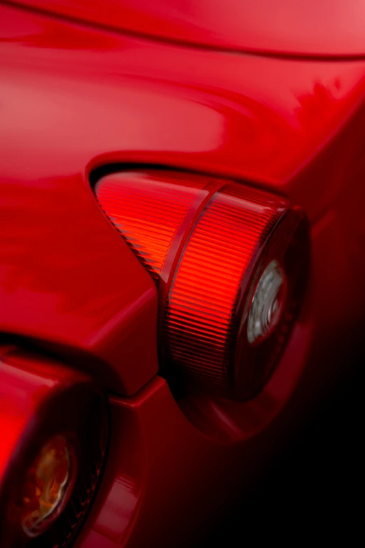 the rear lights of a red sports car