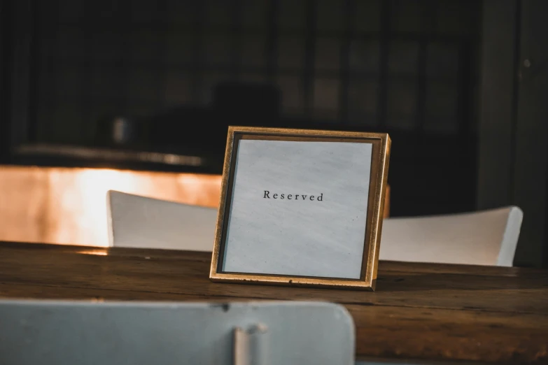 a wooden table topped with a framed picture