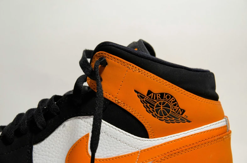 a pair of orange and black high top sneakers