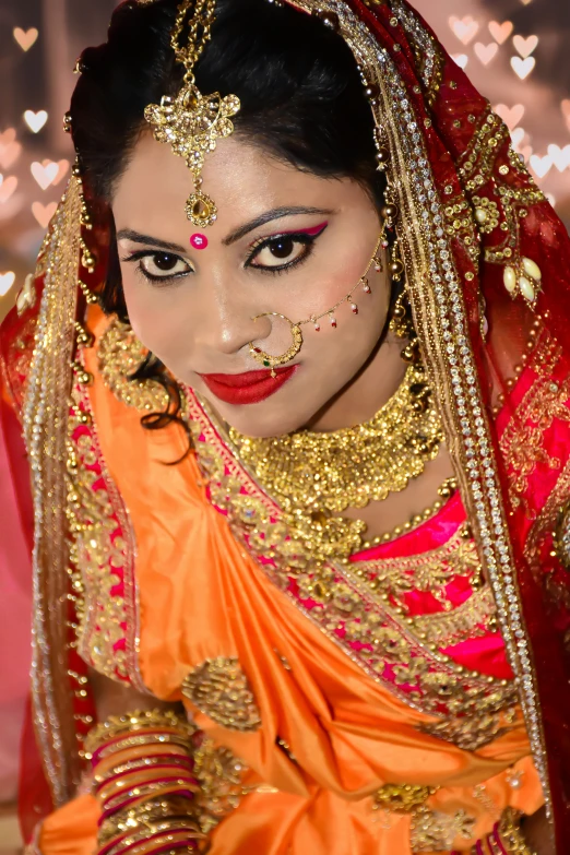 a bride with a red face and gold jewelry